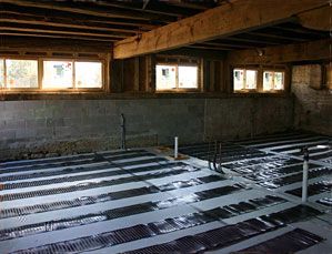 Low-voltage lectric floor heating system being installed.