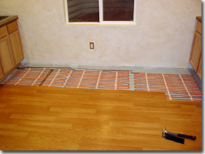 Warm Ribbon floor heating system installed under hardwood floor.